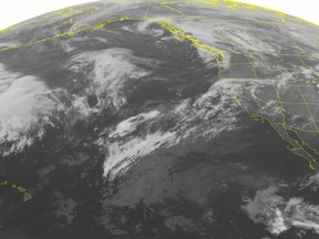 This NOAA satellite image taken Monday, Jan. 19, 2015, at 01:00 AM EST shows a stationary front across the Rocky Mountains and California producing rain showers and snow showers in the higher elevations. A low pressure system on the West Coast of Canada is also producing a mix of rain and snow showers in the Pacific Northwest. A weak low pressure over the Plains is bringing mostly rain with some mixed showers to the Northern and Central Plains. (AP Photo/NOAA via Weather Underground)