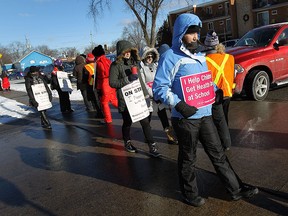 Nurses from the Ontario Nurses Association block cars from entering the parking lot of the strip mall at Tecumseh Road and Rivard Avenue in Windsor on Friday, January 30, 2015. An estimated 3,000 Community Care Access Centre nurses, including about 260 members in Windsor and Essex County, are on strike and want similar wage increase to those of other nurses in other sectors. (TYLER BROWNBRIDGE/The Windsor Star)