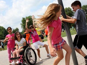 Notre Dame Catholic School students, from left to right, Rocio, Angelina, Vienna, Lily and Kristian, play outside during one of the last recesses of the year, Thursday, June 26, 2014, in the yard behind the school. Catholic school classes officially end June 27. (RICK DAWES/The Windsor Star)