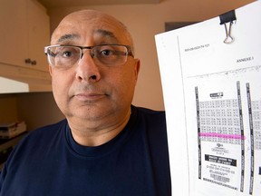 Joel Ifergan holds up a copy of his lottery ticket at his home, Thursday, January 29, 2015 in Montreal. The Supreme Court of Canada refused to hear his case claiming he is owed $13-million for having the winning numbers but the ticket was printed seven seconds after the deadline.THE CANADIAN PRESS/Ryan Remiorz