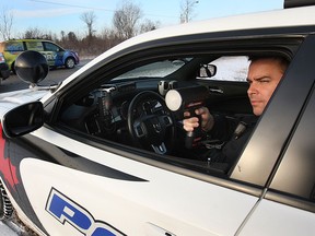 Windsor Police Const. Joe Bohdal from the traffic unit uses a radar gun while looking for speeders along Division Rd. on Tuesday, Jan. 6, 2015, in Windsor, ON. (DAN JANISSE/The Windsor Star)