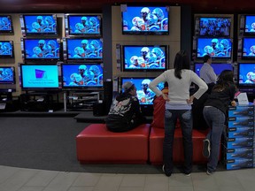 The televisions at the Sony store in Vancouver's Pacific Centre were tuned into the CFL Eastern final, November 22nd, as the BC Lions lose to the Montreal Alouettes. (Ward Perrin / Vancouver Sun)