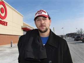 Jesse Small is shown in front of the Target store logo at the Devonshire Mall on Thursday, Jan. 15, 2015, in Windsor, ON. The company announced that it close all their stores in Canada. Small, a sub-contracted custodian at the store says he will be out of work when the store closes.  (DAN JANISSE/The Windsor Star)