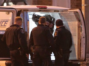 A man in handcuffs is escorted in a  Windsor Police transport van at Canada Customs at the Windsor-Detroit Tunnel in Windsor, Ontario on January 20, 2015.   (The Windsor Star)
