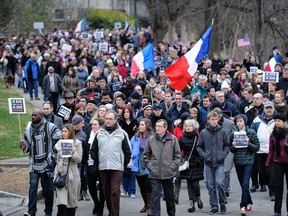 Hundreds of people make their way through Piedmont Park during a silent walk in Atlanta, Sunday, Jan. 11, 2015, to support France after a three-day terrorism spree around Paris that killed 17 people last week. (AP Photo/John Amis)