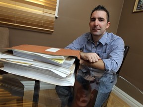 Veteran Bruce Moncur is seen with a massive folder of paper work he has kept since he first filed for compensation in Windsor on Wednesday, January 28, 2015. Moncur suffered a head wound and lost part of his brain while fighting in Afghanistan. He will finally receive compensation. (TYLER BROWNBRIDGE/The Windsor Star)