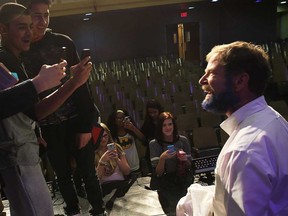 Walkerville Collegiate principal David Garlick made good on his challenge to students on Monday, Jan. 12, 2015, at the Windsor, ON. school. He promised to shave half of his beard and dye the remaining half blue. He challenged the students to donate more canned goods than last year. Students snap cell phone photos of the finished look.  (DAN JANISSE/The Windsor Star)