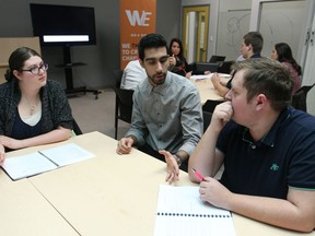 Awais Saleem, centre, leads a small group of hopeful entrepreneurs, including Julie Dipisquale, left, and Richard Ransom-Brown at the opening meeting of WeThrive, which is a program being conducted by Enactus Windsor at the Downtown Business Accelerator, Friday, Jan. 16, 2015.  (DAX MELMER/The Windsor Star)