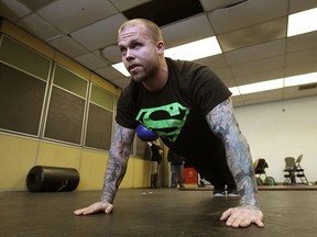 Justice Fournier demonstrates proper pushup technique at Just Training at the Sandwich Teen Action Group in Windsor. (TYLER BROWNBRIDGE / The Windsor Star)