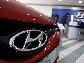 The logo of Hyundai Motor Co. is seen on a car at the automaker's showroom in Seoul, South Korea, Thursday, Jan. 23, 2014. (AP Photo/Lee Jin-man)