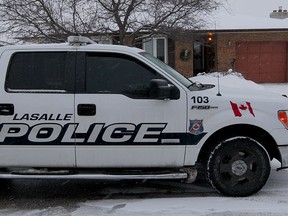 LaSalle Police, shown, and Windsor Police stand guard over single family home at 1317 Carriage Lane in LaSalle, near Windsor Crossings Wednesday February 4, 2015. (NICK BRANCACCIO/The Windsor Star)