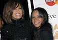 FILE - In this Feb. 12, 2011, file photo, singer Whitney Houston, left, and daughter Bobbi Kristina Brown arrive at an event in Beverly Hills, Calif. The daughter of late singer and entertainer Whitney Houston was found Saturday, Jan. 31, 2015, unresponsive in a bathtub by her husband and a friend and taken to an Atlanta-area hospital. The incident remains under investigation. (AP/Dan Steinberg, File)