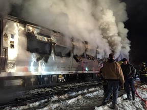 A Metro-North Railroad passenger train smolders after hitting two vehicles in Valhalla, N.Y., Tuesday, Feb. 3, 2015. (AP Photo/The Journal News, Frank Becerra Jr) NYC METRO OUT, TV OUT, MAGS OUT, NO SALES