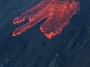 A picture taken on February 5, 2015 shows lava as the Piton de la Fournaise, erupts near the Dolomieu, Bory and Rivals craters on the French Island of Reunion.