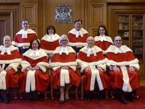 The Supreme Court justices pose for a group photo during the official welcoming ceremony for Supreme Court of Canada Justice Suzanne Cote at the Supreme Court Tuesday Feb.10, 2015 in Ottawa. Top row (left to right) Justice Clement Gascon, Justice Andromache Karakatsanis, Justice Richard Wagner, and Justice Suzanne Cote. Bottom row: (left to right) Justice Thomas Albert, Justice Rosalie Silberman Abella, Justice Beverly McLachlin, Justice Marshall Rothstein and Justice Michael Moldaver. THE CANADIAN PRESS/Adrian Wyld // Na021415-coyne