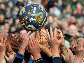 The Up'Ards and the Down'Ards, fight for the ball during the first day of the Royal Shrovetide Football match in Ashbourne, Derbyshire England, Tuesday, Feb. 17, 2015. The Royal Shrovetide Football match, played over two days, occurs annually on Shrove Tuesday and Ash Wednesday in the town of Ashbourne, which hundreds of participants battle it out in a 'no rules' game, where the aim is to get a ball into one of two goals that are positioned three miles apart at either end of Ashbourne.