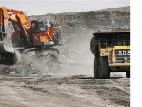 A haul truck carrying a full load drives away from a mining shovel at the Shell Albian Sands oilsands mine near Fort McMurray, Alta., Wednesday, July 9, 2008. If low oil prices stick around much longer, the operations manager at Lac La Biche Transport Ltd. says he will have to layoff workers. These aren't the massive truck-and-shovel mining operations north of Fort McMurray, Alta. that tend to come to mind when one thinks of the oilsands.
(Jeff McIntosh/Postmedia News)