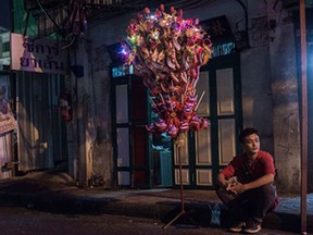A vendor selling goods for the Lunar New Year sits and wait for costumers in the Chinatown area of Bangkok on February 19, 2015. The Lunar New Year, the most important holiday in China and a number of countries in east and southeast Asia, starts on February 19 bringing in the "Year of the Sheep".