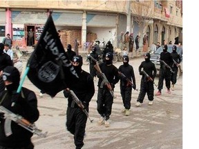 This undated file image posted on a militant website on Jan. 14, 2014, which has been verified and is consistent with other AP reporting, shows fighters from the al-Qaida linked Islamic State of Iraq and the Levant (ISIL) marching in Raqqa, Syria. U.S. Arab allies Egypt, Saudi Arabia, the United Arab Emirates and Kuwait are discussing creation of a military pact to take on Islamic militants, with the possibility of a joint force to intervene around the Middle East, The Associated Press has learned in Nov. 2014. Even if no joint force is agreed on, the alliance would coordinate military action, aiming at quick, pinpoint operations against militants rather than longer missions, officials said. (AP Photo/Militant Website, File)