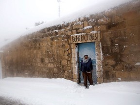 A Palestinian man stands in the snow in east Jerusalem on February 20, 2015, following a heavy storm. People in Jerusalem woke up to around 25 centimetres of snow after the second major blizzard of winter swept across the hilltop Holy City.