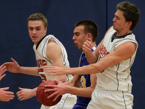 St. Anne's Anthony Zrvnar, centre, is defended by Sandwich's Ross Green, left, and Nate Kristolovich in senior boys basketball action Tuesday. (NICK BRANCACCIO/The Windsor Star)