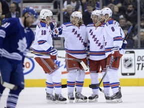 Windsor native Dominic Moore, second from right, celebrates his short-handed goal against the Toronto Maple Leafs with teammates Marc Staal, from left, Carl Hagelin and Kevin Klein Tuesday in Toronto. (THE CANADIAN PRESS/Frank Gunn)