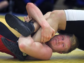 Cooper Chauvin of Essex gets an opponent in an ankle hold during the WECSSAA high school wrestling championships at Tecumseh Vista Academy in Tecumseh Wednesday. (DAN JANISSE/The Windsor Star)