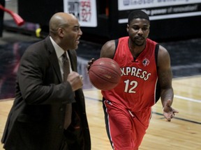 Windsor Express head coach Bill Jones, left, nearly becomes part of the play as Tony Bennett carries the ball against the London Lightning in NBL of Canada action at the  WFCU Centre February 13, 2015. (NICK BRANCACCIO/The Windsor Star)