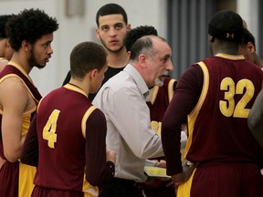 Catholic Central Comets head coach Pete Cusumano, centre, speaks to the players during a time out against the Holy Names Knights in boys high school basketball at the Holy Names gym. (NICK BRANCACCIO/The Windsor Star)