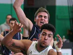 Sandwich's Nathan Kristalovich, top, and Herman's Kaine Stevenson battle for a loose ball during a WECSSAA boys basketball preliminary game between the Herman Green Griffins and the visiting Sandwich Sabres Friday. (DAX MELMER/The Windsor Star)