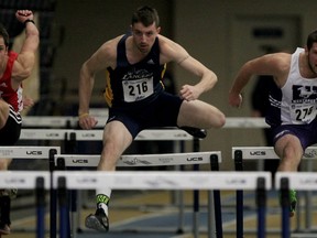 University of Windsor's Mat West, centre, competes in the 60M hurdles portion of the men's pentathlon at the St. Denis Centre. York's Justin Massar, left, and Western University's Michael Paisley, right, stay close but West won the heat in 8.77 seconds. (NICK BRANCACCIO/The Windsor Star)