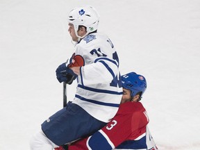 Montreal's Mike Weaver, right, collides with Toronto's David Clarkson Saturday  in Montreal. (THE CANADIAN PRESS/Graham Hughes)