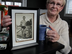 Lynne St. Germain with family photographs of her father Jerry Shaw who died on his 100th birthday February 9, 2015.  With movie star looks and a chiseled physique, Shaw would routinely swim across the Detroit River from Windsor area swimming holes.  (NICK BRANCACCIO/The Windsor Star)
