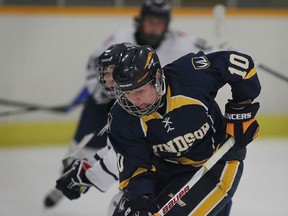 Krystin Lawrence of the Windsor Lancers battles for a loose puck against Toronto's Stacey Oue, behind, in first period of their OUA playoff quarterfinal at South Windsor Arena, Thursday February 19, 2015. (NICK BRANCACCIO/The Windsor Star)