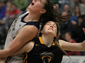 University of Windsor Lancers Andrea Kiss, left, collides with Waterloo Warriors Madison Behr during the OUA women's basketball game at the St. Denis Centre in Windsor, Ontario on June 18, 2015. (JASON KRYK/The Windsor Star)