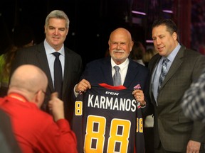 Former owner of the Windsor Compuware Spitfires Peter Karmanos, centre, poses with former Whalers head coach Mike Vellucci and current Spits GM Warren Rychel, right, at WFCU Centre on Mickey Renaud Night Wednesday February 18, 2015.  Karmanos also owned the Plymouth Whalers which are moving to Flint, Michigan.  (NICK BRANCACCIO/The Windsor Star)