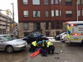 Paramedics tend to a pedestrian who was struck by a vehicle on Park Street near Pelissier Street in downtown Windsor on Feb. 11, 2015. (Dan Janisse/The Windsor Star)