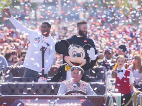 ANAHEIM, CA - FEBRUARY 02: In this handout image provided by Disneyland, New England Patriots players Julian Edelman (right) and Malcolm Butler were joined by Mickey Mouse as they celebrated their team's Super Bowl XLIX championship victory with a special cavalcade down Main Street, U.S.A. at Disneyalnd park in Anaheim, Calif., on Monday. In the frenzied moments following their team's feat of capturing the National Football League championship on Sunday, Edelman and Butler stood in front of a TV camera and shouted four words that have become an iconic reaction to milestone achievement: "We're going to Disneyland!" (Photo by Paul Hiffmeyer/Disneyland via Getty Images)