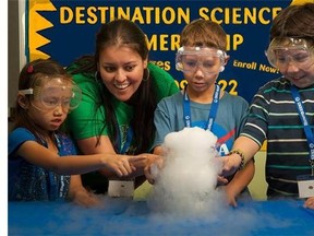 This undated photo provided by Destination Science shows, teacher Suman VonWolzogen, second left, and young campers "Observing Sublimation" at Destination Science Camp in Fullerton, Calif. STEM summer camps, focusing on science, technology, engineering and math, are more popular and plentiful than ever. (AP Photo/Destination Science, Jon C. Haverstick)