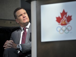 Chris Overholt, chief executive officer of the Canadian Olympic Committee, listens to a question during a press conference for the Pan American Games. (Aaron Lynett/National Post)
