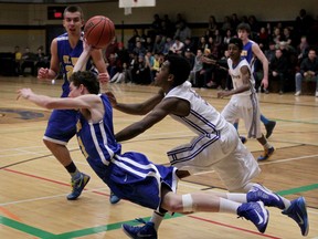 St. Anne's Ryan McManus, left, and Kennedy's Juwan Lynch collide while chasing a loose ball during a high school boys basketball semifinal at Kennedy. (NICK BRANCACCIO/The Windsor Star)