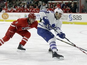 Toronto's Nazem Kadri, right, is checked by Carolina's Elias Lindholm Friday in Raleigh, N.C. (AP Photo/Gerry Broome)