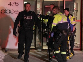 Paramedics and Windsor police remove a female victim from the apartment building at 475 Bruce Ave. on the night of Feb. 23, 2015. A 26-year-old WIndsor male has been charged with murder. (Nick Brancaccio / The Windsor Star)