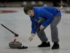Drew Denomy of Belle River sweeps for his team in game against St. Joseph in curling action from Roseland Curling Club Monday. (NICK BRANCACCIO/The Windsor Star)