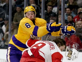 Kings defenceman Jake Muzzin, left, checks Detroit's Justin Abdelkader during the first period Tuesday in Los Angeles. (AP Photo/Chris Carlson)