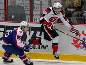 Ottawa 67s Jacob Middleton jumps past the check of Spits Cristiano DiGiacinto in first period of OHL action from WFCU Centre Thursday February 26, 2015. (NICK BRANCACCIO/The Windsor Star)