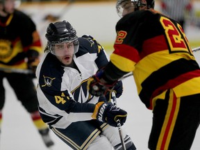 University of Windsor Lancers Dylan Seguin, left, carries the puck against Guelph's Nicholas Trecapelli in OUA playoff hockey at South Windsor Arena February 25, 2015. (NICK BRANCACCIO/The Windsor Star)