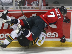 Spits forward Adam Wallace, right, flattens Brampton's Ben Alavie at the WFCU Centre. (DAN JANISSE/The Windsor Star)