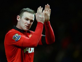 Manchester United's English striker Wayne Rooney leaves the field after the English Premier League match between Manchester United and Fulham at Old Trafford in Manchester on February 9, 2014.  (AFP PHOTO/ANDREW YATES)