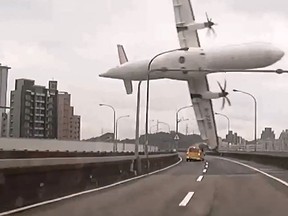 This screen grab taken from video provided courtesy of TVBS Taiwan on February 4, 2015 shows a TransAsia ATR 72-600 turboprop plane clipping an elevated motorway and hitting a taxi (C) before crashing into the Keelung river outside Taiwan's capital Taipei in New Taipei City. Taiwan/AFP/Getty Images